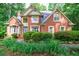 Charming brick home with a well-manicured lawn and mature landscaping at 745 Devon Hill Ct, Roswell, GA 30075
