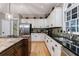 Modern kitchen featuring white cabinets, granite countertops, stainless steel appliances, and stylish fixtures at 745 Devon Hill Ct, Roswell, GA 30075