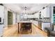 Bright kitchen with granite countertops, white cabinets, and a large island at 745 Devon Hill Ct, Roswell, GA 30075