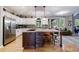 Gourmet kitchen with a large center island, stainless steel appliances, and custom lighting at 745 Devon Hill Ct, Roswell, GA 30075