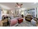 Open living room with hardwood floors, ceiling fan, and stairs to upper level at 745 Devon Hill Ct, Roswell, GA 30075