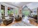 Inviting living room with hardwood floors, abundant natural light, and comfortable seating at 745 Devon Hill Ct, Roswell, GA 30075