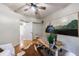 Bright office space with hardwood floors, a large painting, and a ceiling fan at 745 Devon Hill Ct, Roswell, GA 30075