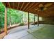 Covered patio with a ceiling fan and view of the wooded backyard perfect for relaxation and entertaining at 745 Devon Hill Ct, Roswell, GA 30075