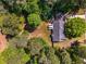 Aerial shot showcasing the home, a spacious backyard, and surrounding lush greenery at 45 Pine Tree Dr, Mcdonough, GA 30252