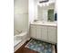 Bright bathroom featuring a tub and shower combo, vanity, and patterned rug for comfort at 45 Pine Tree Dr, Mcdonough, GA 30252