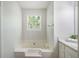 Bathroom with a tub and shower combo, and vanity with ample storage space for toiletries at 45 Pine Tree Dr, Mcdonough, GA 30252