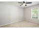 Bedroom features a ceiling fan, a large window, and carpet, creates a welcoming, cozy feel at 45 Pine Tree Dr, Mcdonough, GA 30252