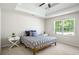 Bright bedroom featuring a tray ceiling, large window, and neutral decor, creating a serene atmosphere at 45 Pine Tree Dr, Mcdonough, GA 30252