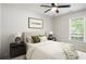 Bedroom with a ceiling fan, a large window, and neutral colors, creates a relaxing retreat at 45 Pine Tree Dr, Mcdonough, GA 30252