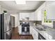 Well-lit kitchen with granite countertops, stainless steel appliances, and white cabinetry at 45 Pine Tree Dr, Mcdonough, GA 30252