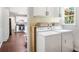 Laundry room with modern appliances, cabinets, and a view to the kitchen, for easy multi-tasking at 45 Pine Tree Dr, Mcdonough, GA 30252