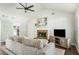 Inviting living room showcasing a fireplace, vaulted ceilings, hardwood floors, and comfortable furnishings at 45 Pine Tree Dr, Mcdonough, GA 30252