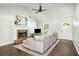 Bright living room featuring a cozy fireplace, vaulted ceilings, hardwood floors, and a neutral color palette at 45 Pine Tree Dr, Mcdonough, GA 30252