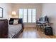 Cozy bedroom with hardwood floors, shutters, and a dedicated workspace with modern computer equipment at 89 E Andrews Nw Dr, Atlanta, GA 30305