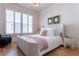 Comfortable bedroom featuring hardwood floors, plantation shutters, and stylish decor at 89 E Andrews Nw Dr, Atlanta, GA 30305