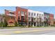 Stylish multi-story townhome complex featuring brick and painted exteriors with awnings and balconies at 89 E Andrews Nw Dr, Atlanta, GA 30305