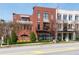 Beautiful brick multi-story townhome featuring awnings, large windows, and professional landscaping at 89 E Andrews Nw Dr, Atlanta, GA 30305