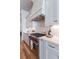 Close up of a modern kitchen with white cabinets, marble backsplash, and stainless steel range at 89 E Andrews Nw Dr, Atlanta, GA 30305