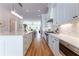 Open-concept kitchen boasts stainless steel appliances, a large island, and a view to the living room at 89 E Andrews Nw Dr, Atlanta, GA 30305
