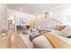 Bright and airy living room with hardwood floors, modern furniture, and a decorative brick wall at 89 E Andrews Nw Dr, Atlanta, GA 30305