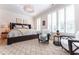 Bright main bedroom featuring a chandelier, plush bed, and window shutters at 89 E Andrews Nw Dr, Atlanta, GA 30305