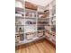 Well-organized pantry featuring wooden floors, open shelving and various storage containers at 89 E Andrews Nw Dr, Atlanta, GA 30305