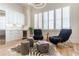 Stylish sitting area with a wine fridge, zebra rug, unique chairs, and natural light from the window at 89 E Andrews Nw Dr, Atlanta, GA 30305