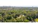 Breathtaking aerial view of a house nestled amongst mature green trees with city skyline views at 1178 Roxboro Ne Cv, Atlanta, GA 30324