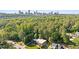 An aerial view of a charming home surrounded by mature trees and skyline views at 1178 Roxboro Ne Cv, Atlanta, GA 30324