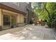 Expansive backyard view with a large patio, lush greenery, and mature trees offering privacy at 1178 Roxboro Ne Cv, Atlanta, GA 30324