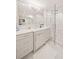 Bright bathroom features marble flooring, white cabinets, and frameless shower door at 1178 Roxboro Ne Cv, Atlanta, GA 30324