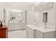 Bright bathroom with double vanity sinks, white cabinets, and updated lighting fixtures at 1178 Roxboro Ne Cv, Atlanta, GA 30324