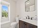 Cozy bathroom with wood vanity, modern faucet, and natural light from the window at 1178 Roxboro Ne Cv, Atlanta, GA 30324