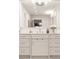 Bathroom vanity with granite countertops, white cabinets and modern chrome faucet at 1178 Roxboro Ne Cv, Atlanta, GA 30324