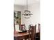 A dining room with a dark wood table and modern light fixture at 1178 Roxboro Ne Cv, Atlanta, GA 30324