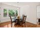A dining room with hardwood floors and a wood table with natural light from the windows at 1178 Roxboro Ne Cv, Atlanta, GA 30324