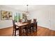Elegant dining room with dark wood table, modern light fixture, and natural light from the window at 1178 Roxboro Ne Cv, Atlanta, GA 30324
