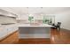 A large kitchen with a gray island, stainless appliances, and hardwood floors at 1178 Roxboro Ne Cv, Atlanta, GA 30324