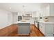 Bright kitchen features an island, stainless appliances, white cabinets, and hardwood floors at 1178 Roxboro Ne Cv, Atlanta, GA 30324
