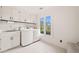 Well-lit laundry room with modern appliances, ample storage, and a window providing natural light at 1178 Roxboro Ne Cv, Atlanta, GA 30324