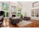 Elegant living room with high ceilings, fireplace, hardwood floors, and natural light at 1178 Roxboro Ne Cv, Atlanta, GA 30324