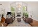 Bright living room with a beautiful fireplace, hardwood floors and large windows at 1178 Roxboro Ne Cv, Atlanta, GA 30324