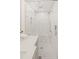 Close up of shower with marble tiles, glass enclosure, and chrome fixtures at 1178 Roxboro Ne Cv, Atlanta, GA 30324