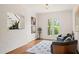 Cozy sitting room with brick accent wall, seating area, and natural light at 1178 Roxboro Ne Cv, Atlanta, GA 30324