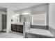 Bright main bathroom showcasing a soaking tub, glass-enclosed shower, and double sink vanity at 2251 Nancy Creek Dr, Atlanta, GA 30341
