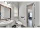Elegant bathroom featuring a pedestal sink, toilet, and an open doorway to the bedroom at 2251 Nancy Creek Dr, Atlanta, GA 30341