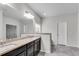 Well-lit bathroom with double sinks, granite countertops, and ample storage space in dark wood cabinets at 2251 Nancy Creek Dr, Atlanta, GA 30341