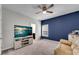 Cozy bedroom featuring a mounted TV, accent wall, and comfortable seating area to relax and unwind at 2251 Nancy Creek Dr, Atlanta, GA 30341