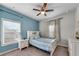 Charming bedroom featuring a ceiling fan, a cozy bed, and ample natural light from the window at 2251 Nancy Creek Dr, Atlanta, GA 30341